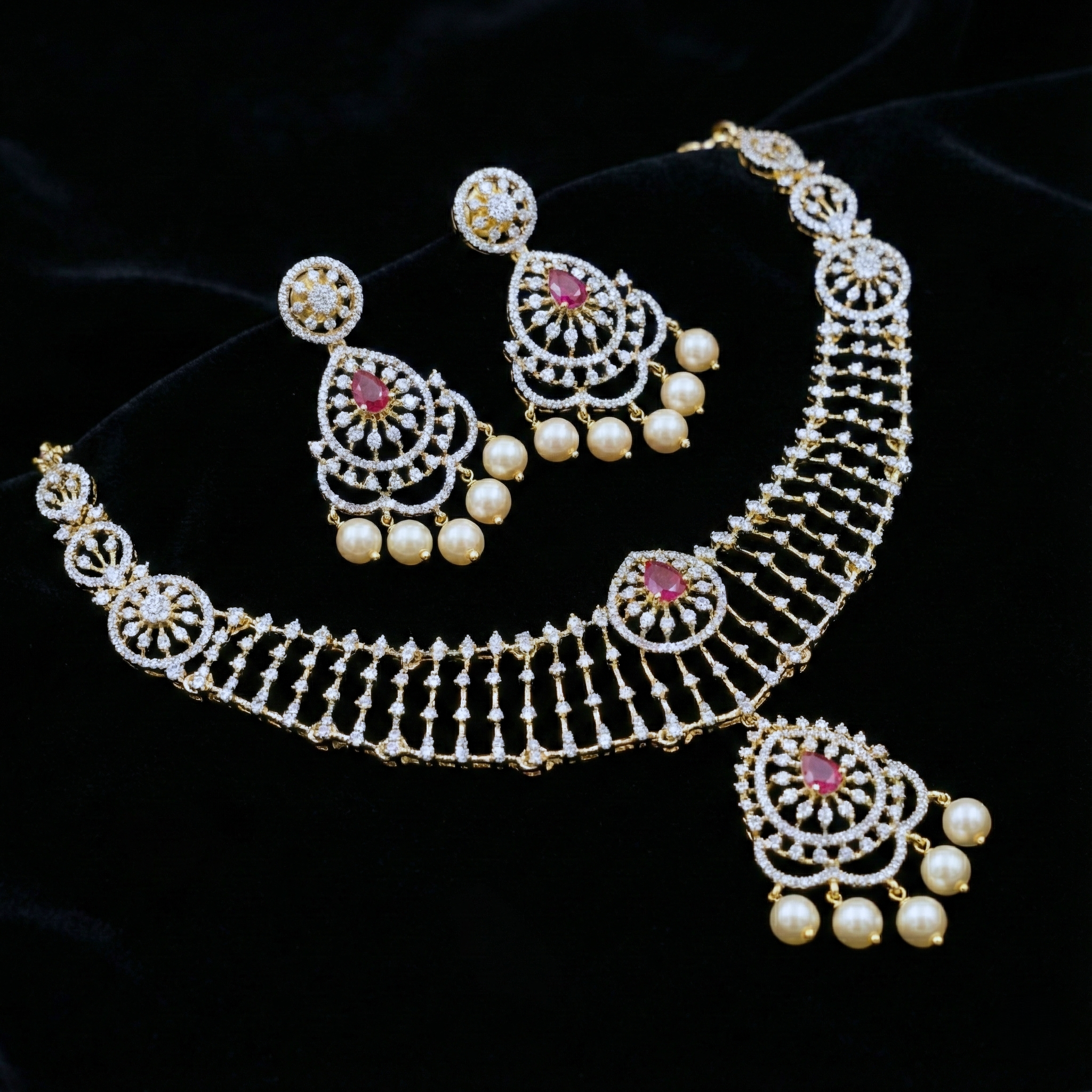 Ornate necklace with matching earrings on a black background
